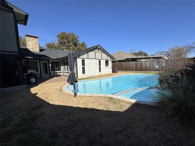 view of swimming pool with a fenced in pool, a patio area, a yard, and fence