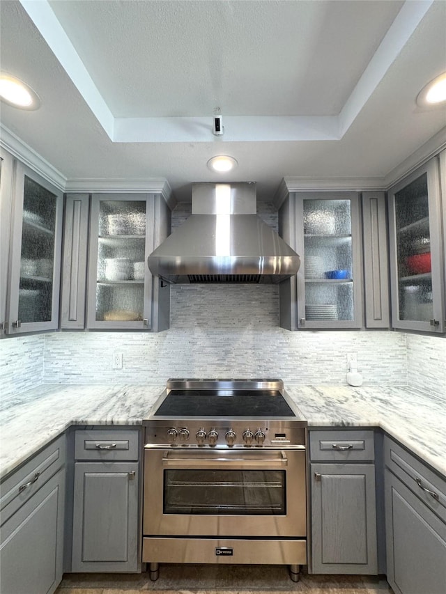 3200 Dover Dr, Plano, TX 75075 - kitchen featuring wall chimney range hood, high end stainless steel range, gray cabinetry, a raised ceiling, and recessed lighting