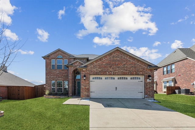 traditional-style house featuring a front yard, cooling unit, brick siding, and driveway