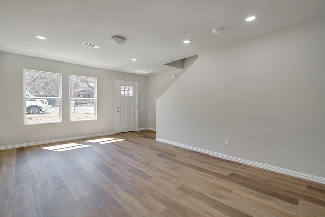 entrance foyer with recessed lighting, visible vents, baseboards, and wood finished floors