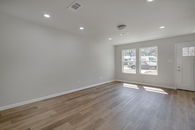 foyer with visible vents, baseboards, and wood finished floors