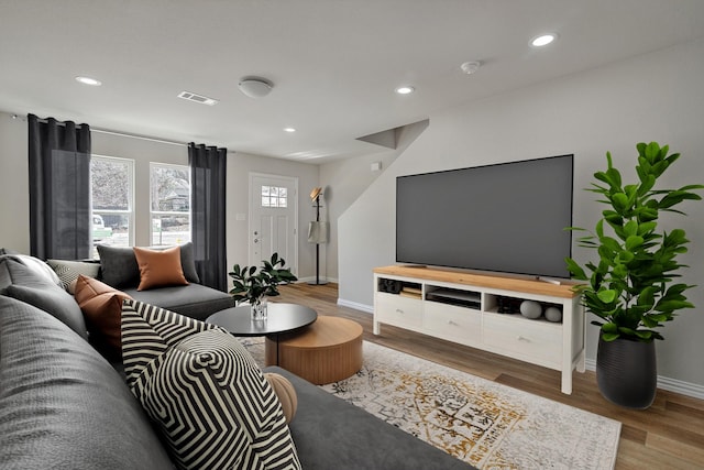 3231 Comanche St, Fort Worth, TX 76119 - living room featuring baseboards, wood finished floors, visible vents, and recessed lighting