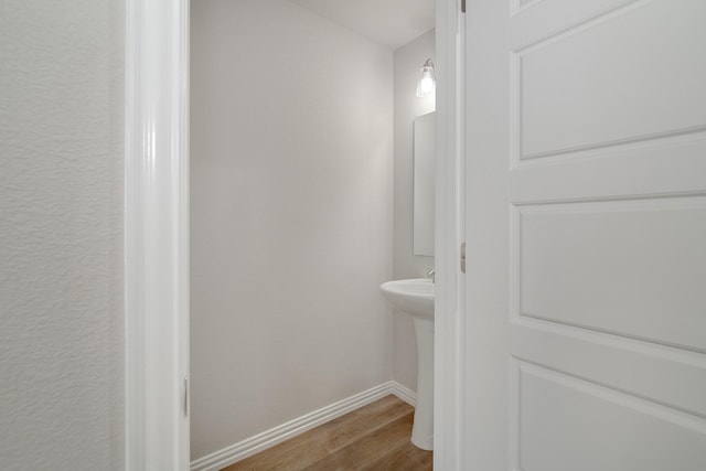 bathroom featuring baseboards and wood finished floors