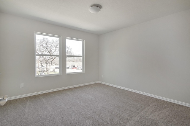 empty room with carpet flooring and baseboards