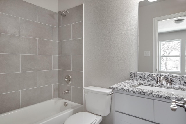 3231 Comanche St, Fort Worth, TX 76119 - full bathroom with a textured wall, vanity, tub / shower combination, and toilet