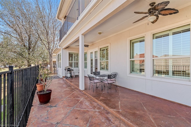 view of patio featuring outdoor dining space, grilling area, and ceiling fan