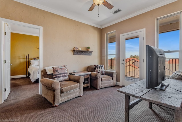 living room with visible vents, ornamental molding, a ceiling fan, carpet flooring, and baseboards