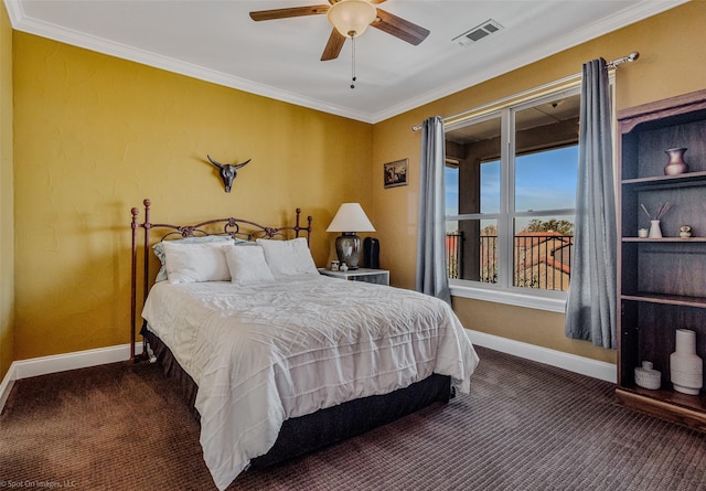 carpeted bedroom featuring visible vents, baseboards, ornamental molding, and a ceiling fan