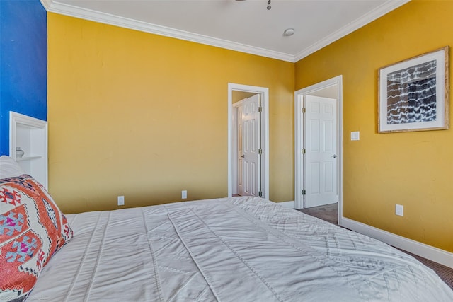 bedroom featuring crown molding and baseboards