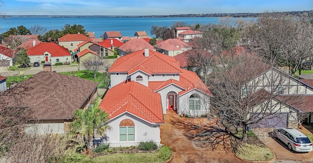 drone / aerial view featuring a residential view and a water view