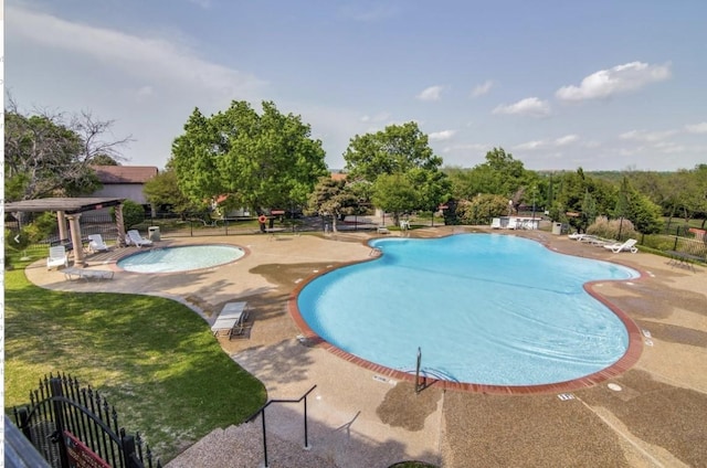 pool with a patio, a yard, and fence