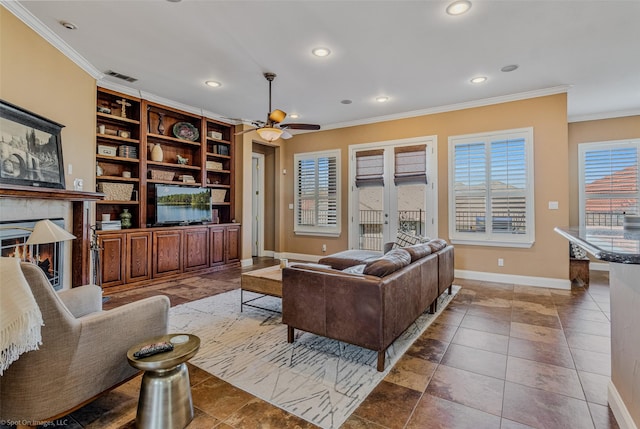 living area with visible vents, a glass covered fireplace, recessed lighting, crown molding, and baseboards