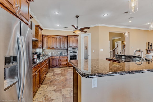 kitchen with brown cabinetry, stainless steel appliances, crown molding, decorative light fixtures, and tasteful backsplash