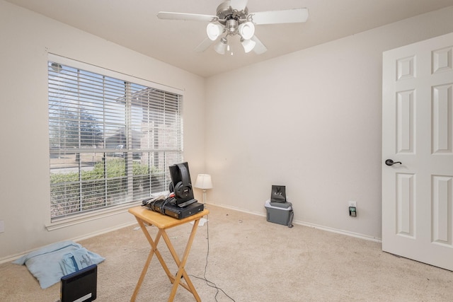 interior space with baseboards, carpet, and ceiling fan