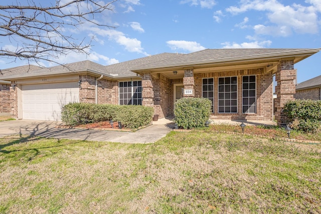 ranch-style home with brick siding, a shingled roof, concrete driveway, a front yard, and an attached garage