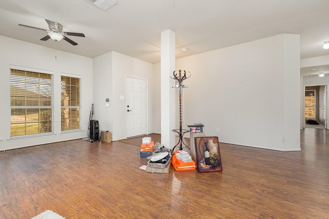 interior space with wood finished floors, visible vents, and ceiling fan