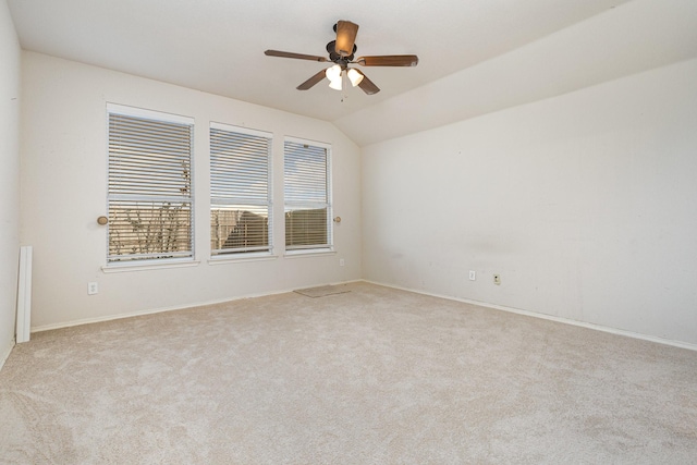 carpeted empty room featuring lofted ceiling and a ceiling fan