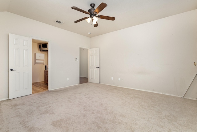 unfurnished bedroom with lofted ceiling, visible vents, carpet floors, and ceiling fan