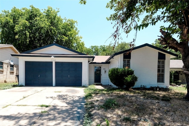 ranch-style home with an attached garage and driveway