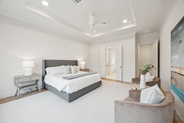 bedroom with recessed lighting, a raised ceiling, baseboards, and wood finished floors