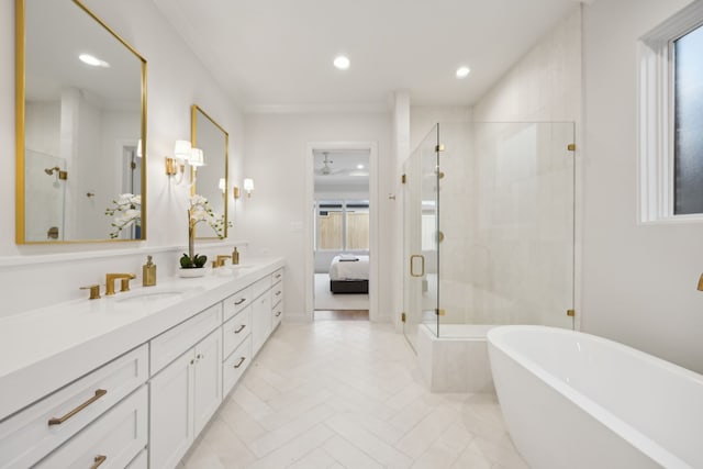 bathroom with a sink, a soaking tub, double vanity, and a shower stall