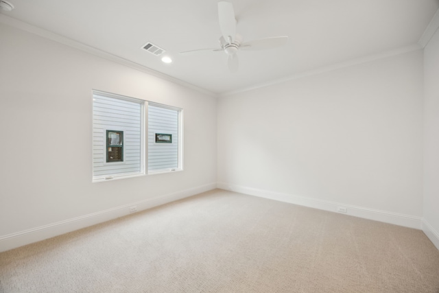 unfurnished room featuring baseboards, light colored carpet, visible vents, and ornamental molding