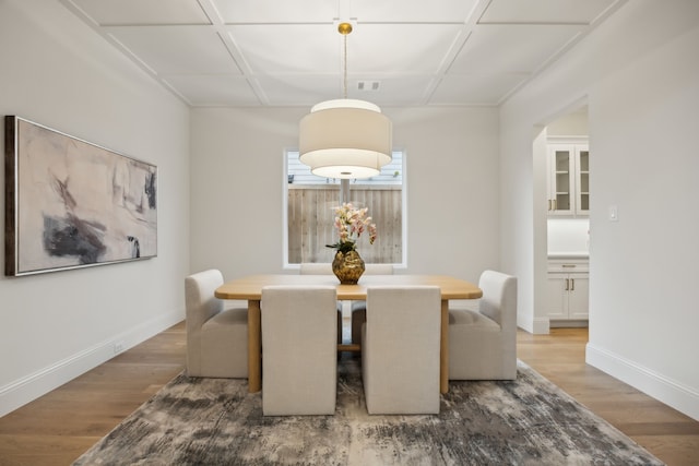 dining room featuring baseboards and wood finished floors