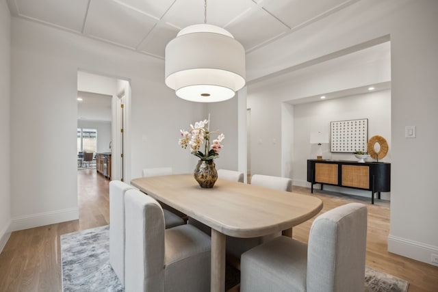 dining area featuring recessed lighting, coffered ceiling, light wood-type flooring, and baseboards