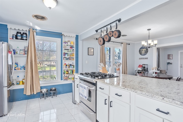 kitchen featuring visible vents, light stone counters, stainless steel appliances, white cabinets, and crown molding