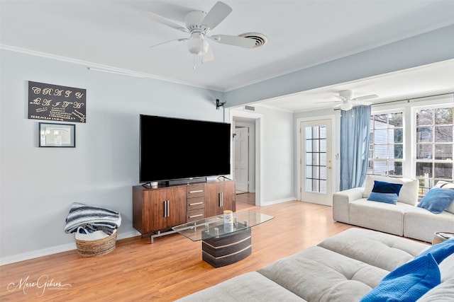 living room featuring baseboards, light wood-type flooring, ceiling fan, and ornamental molding