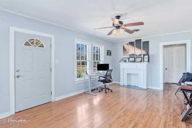 office area with light wood-style flooring, crown molding, and baseboards