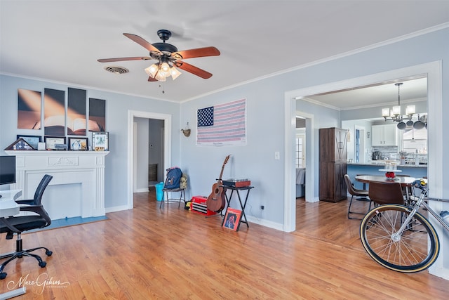 office space featuring light wood finished floors, visible vents, and ornamental molding