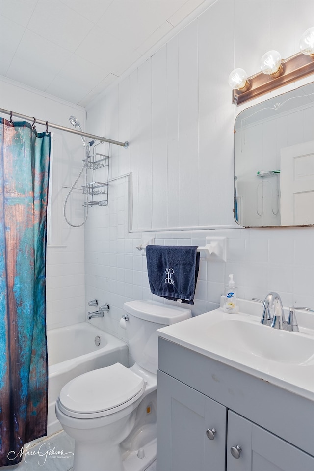 bathroom featuring toilet, shower / bath combo with shower curtain, vanity, decorative backsplash, and tile walls