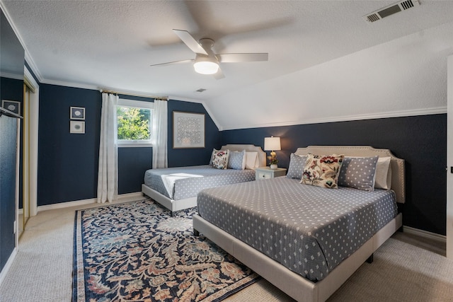 bedroom featuring visible vents, lofted ceiling, a textured ceiling, and baseboards