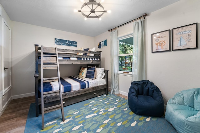 bedroom with baseboards and wood finished floors