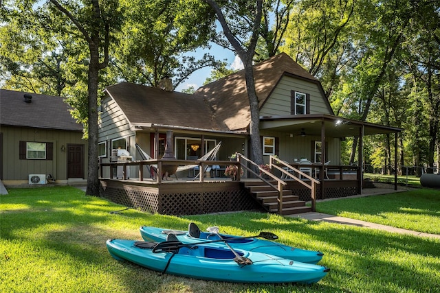 back of property with a yard, a chimney, and a deck