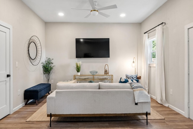 living room with a ceiling fan, recessed lighting, and wood finished floors