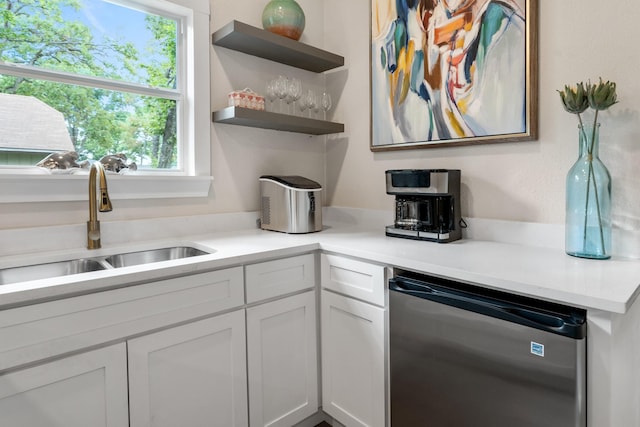 kitchen with a sink, dishwasher, light countertops, white cabinetry, and open shelves