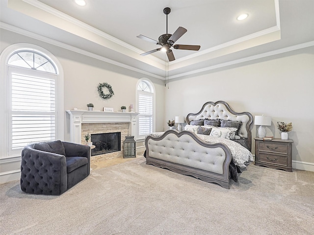 bedroom featuring a tray ceiling, carpet, and ornamental molding