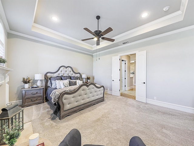 bedroom featuring visible vents, carpet flooring, a tray ceiling, and ornamental molding