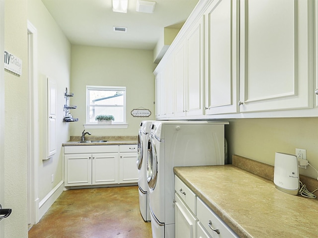 laundry room featuring a sink, visible vents, cabinet space, and independent washer and dryer