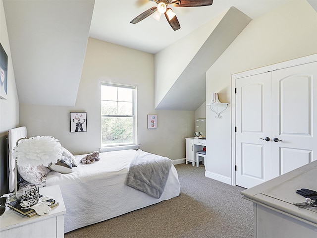 carpeted bedroom featuring a closet, a ceiling fan, baseboards, and vaulted ceiling