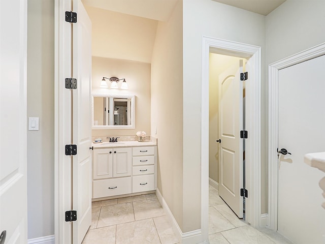 bathroom with baseboards and vanity