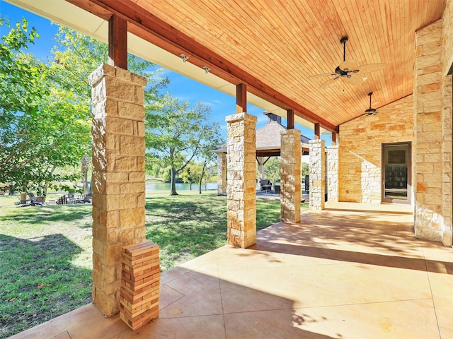 view of patio featuring a ceiling fan and a water view