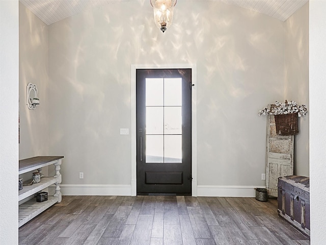 entrance foyer with baseboards, wood finished floors, and vaulted ceiling