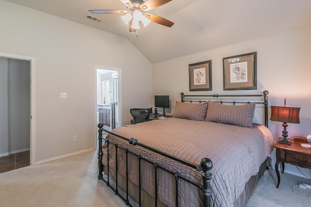 bedroom featuring visible vents, connected bathroom, baseboards, vaulted ceiling, and light carpet