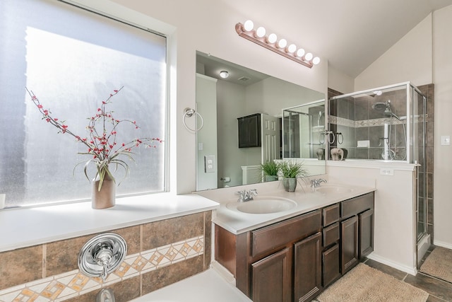 full bathroom with a sink, lofted ceiling, double vanity, and a shower stall