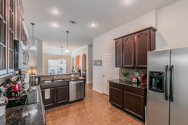 kitchen featuring visible vents, dark brown cabinets, appliances with stainless steel finishes, and a sink