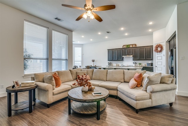 living room featuring recessed lighting, visible vents, and dark wood-style floors