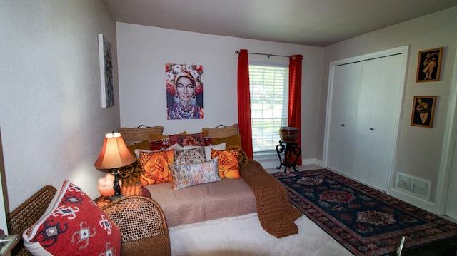 bedroom with a closet and visible vents